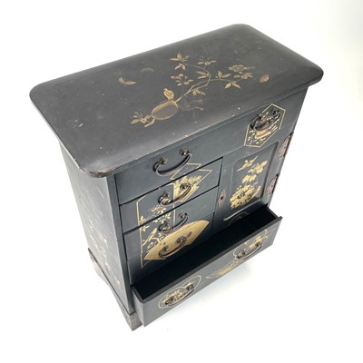 Lot 318 - A Japanese black lacquered small cabinet.