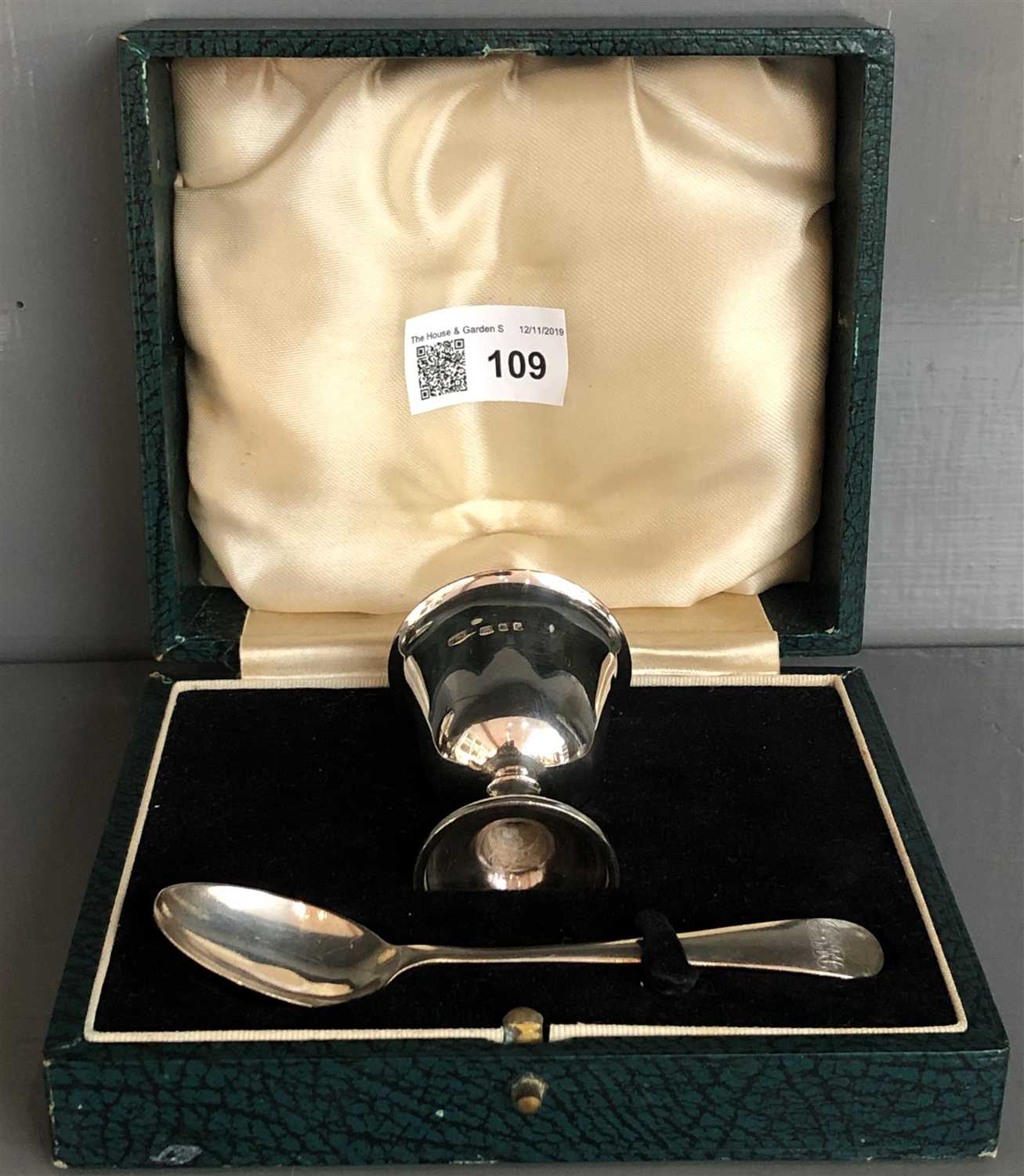 Lot 109 - A Silver plain egg cup and spoon, cased, 2oz.