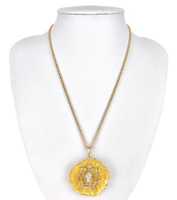 Lot 109 - A modern 9ct bi-colour gold zodiac Libra brooch pendant necklace.