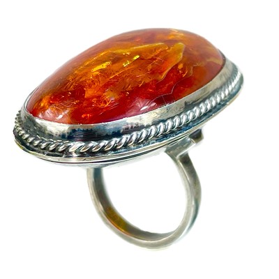 Lot 419 - A large 800 silver and amber ring.