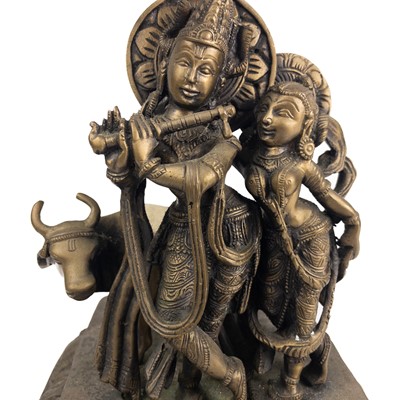 Lot 88 - An Indian bronze figure of Krishna beneath a tree.