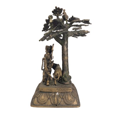 Lot 88 - An Indian bronze figure of Krishna beneath a tree.