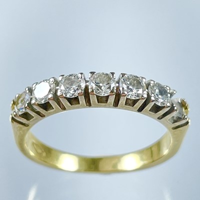 Lot 118 - An 18ct diamond hoop set ring with six round cut stones, one missing.