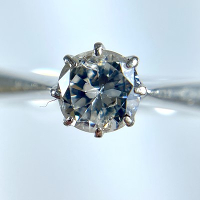 Lot 366 - A platinum (tested) diamond solitaire ring and a platinum (tested) band ring.
