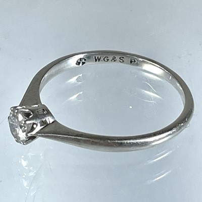 Lot 366 - A platinum (tested) diamond solitaire ring and a platinum (tested) band ring.