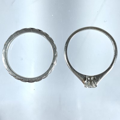 Lot 366 - A platinum (tested) diamond solitaire ring and a platinum (tested) band ring.