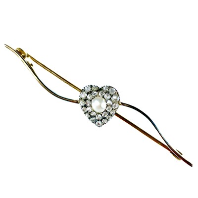 Lot 111 - An Edwardian gold diamond and half pearl set heart shaped bar brooch.