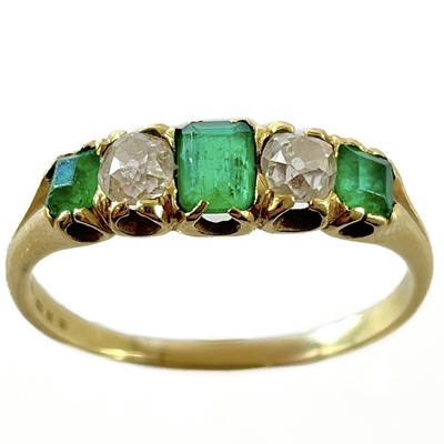 Lot 137 - A high purity gold (tests 18ct) emerald and diamond five stone ring.