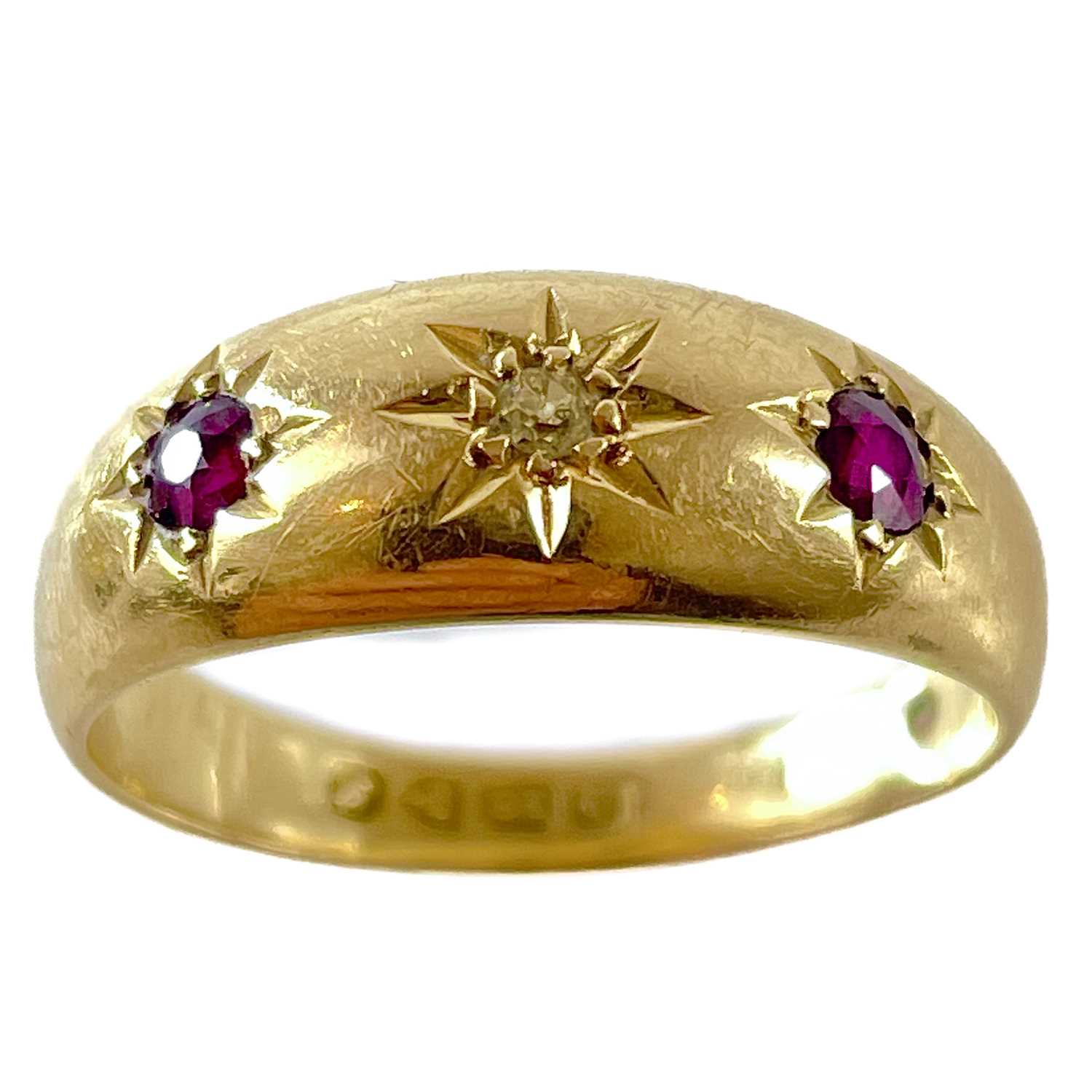 Lot 83 - An 18ct gypsy set diamond and ruby three stone ring.