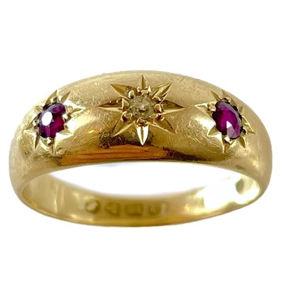 Lot 83 - An 18ct gypsy set diamond and ruby three stone ring.