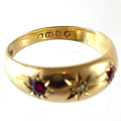 Lot 83 - An 18ct gypsy set diamond and ruby three stone ring.