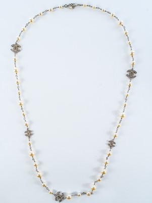 Lot 559 - A Chanel white metal cultured pearl and white gem set CC long necklace.