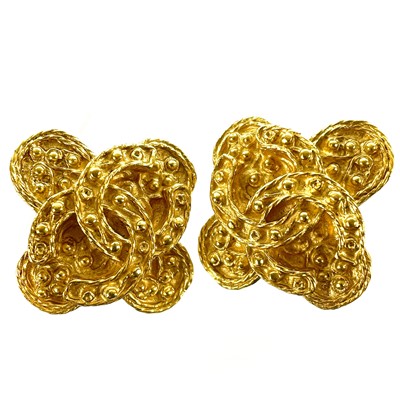 Lot 564 - A pair of Chanel gold plated clover clip earrings.