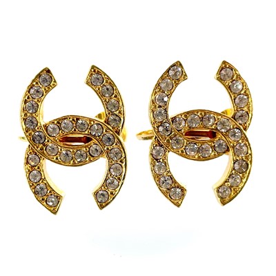 Lot 534 - A pair of Chanel CC gold plated and crystal set clip earrings.