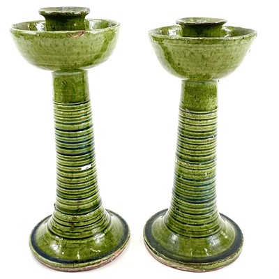 Lot 169 - A pair of Ewenny green glazed pottery candlesticks.