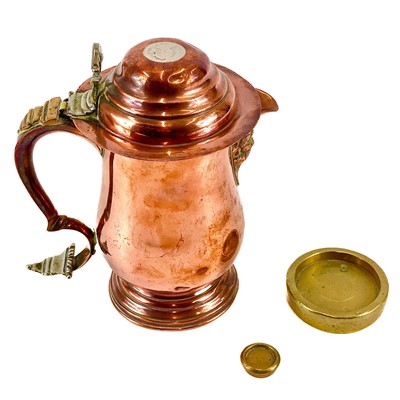 Lot 158 - A copper and brass bound face mask lidded jug.