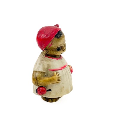 Lot 24 - A celluloid novelty tape measure modelled as a young girl.