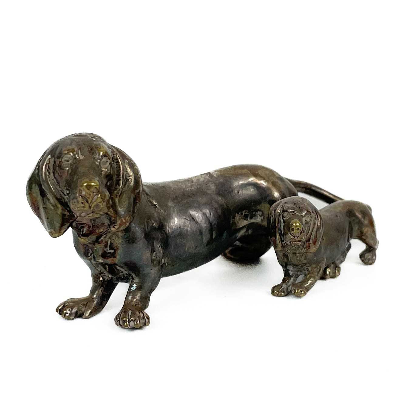 Lot 402 - A silver plated bronze model of a Dachshund with puppy.