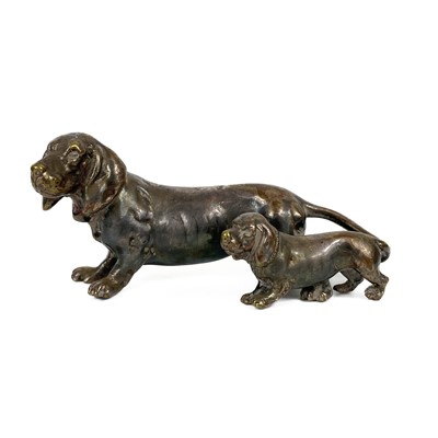 Lot 402 - A silver plated bronze model of a Dachshund with puppy.