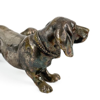 Lot 402 - A silver plated bronze model of a Dachshund with puppy.