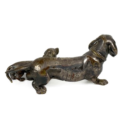 Lot 402 - A silver plated bronze model of a Dachshund with puppy.