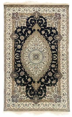 Lot 183 - A Persian part silk and wool rug, signed .