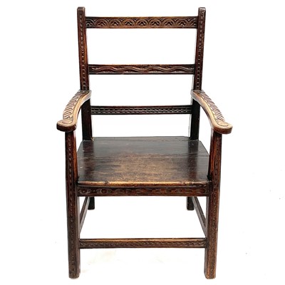 Lot 132 - A carved oak and walnut open armchair.