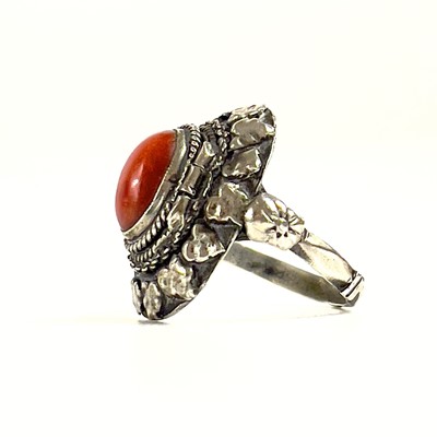 Lot 41 - An 800 silver coral set locket ring.