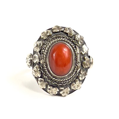 Lot 41 - An 800 silver coral set locket ring.