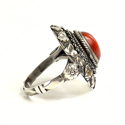 Lot 41 - An 800 silver coral set locket ring.