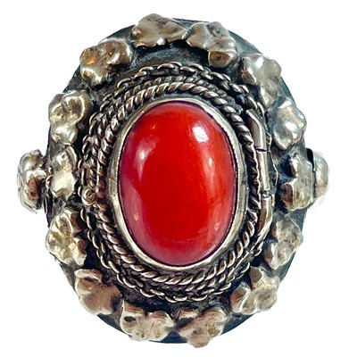 Lot 41 - An 800 silver coral set locket ring.