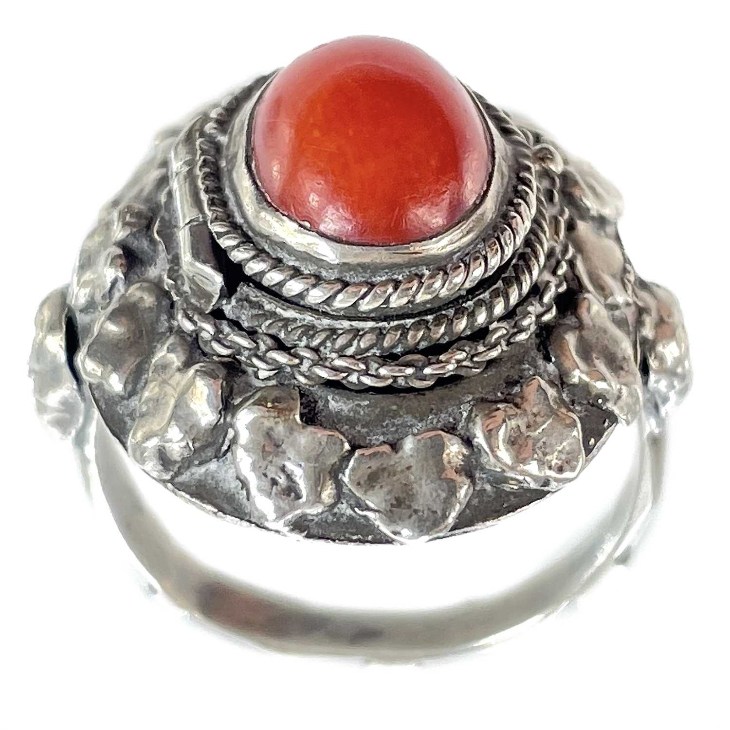 Lot 41 - An 800 silver coral set locket ring.