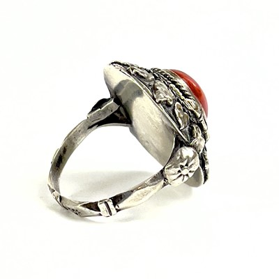 Lot 41 - An 800 silver coral set locket ring.