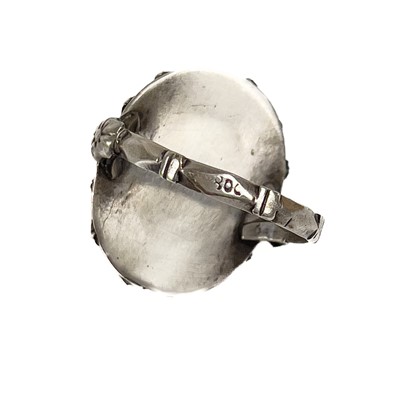 Lot 41 - An 800 silver coral set locket ring.