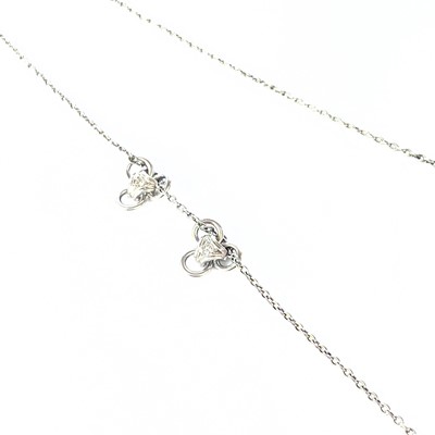 Lot 105 - A platinum necklace with two sliding diamond set pendants.