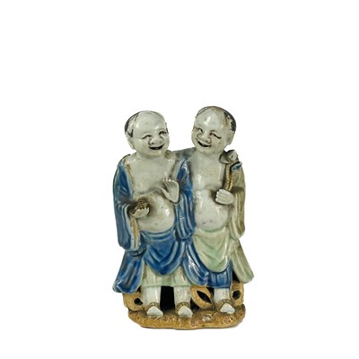 Lot 281 - A Chinese glazed group of the Hehe Er Xian twins, early 20th century.