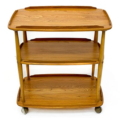 Lot 431 - An Ercol Windsor light elm three tier trolley with lipped edges.