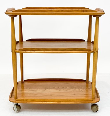Lot 431 - An Ercol Windsor light elm three tier trolley with lipped edges.