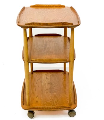 Lot 431 - An Ercol Windsor light elm three tier trolley with lipped edges.