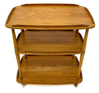Lot 431 - An Ercol Windsor light elm three tier trolley with lipped edges.