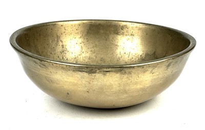 Lot 284 - A Tibetan hammered and polished bronze singing bowl.