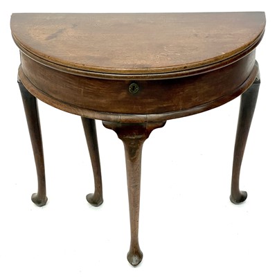 Lot 1825 - A George II mahogany demi lune fold top table.