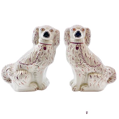 Lot 239 - A pair of Victorian Staffordshire pink lustre spaniels.