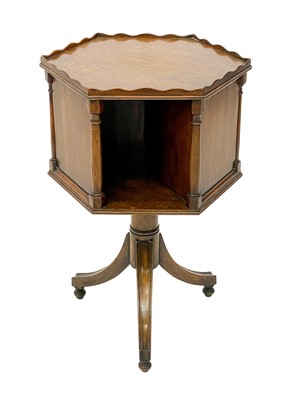 Lot 1870 - A 19th century mahogany hexagonal revolving bookcase on swept tripod supports.