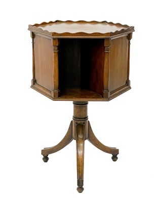 Lot 1870 - A 19th century mahogany hexagonal revolving bookcase on swept tripod supports.