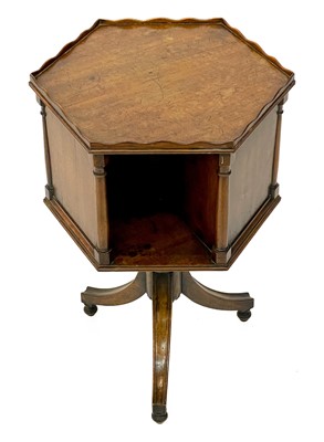 Lot 1870 - A 19th century mahogany hexagonal revolving bookcase on swept tripod supports.