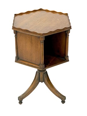 Lot 1870 - A 19th century mahogany hexagonal revolving bookcase on swept tripod supports.
