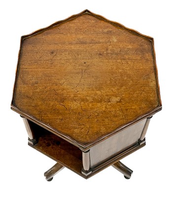 Lot 1870 - A 19th century mahogany hexagonal revolving bookcase on swept tripod supports.