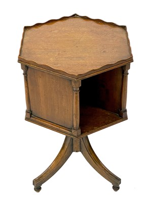 Lot 1870 - A 19th century mahogany hexagonal revolving bookcase on swept tripod supports.