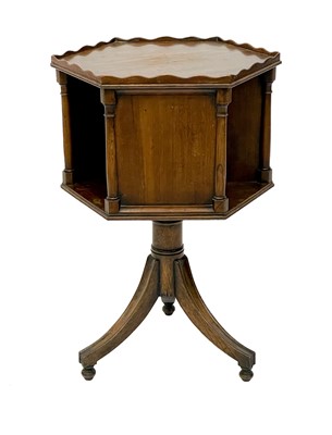Lot 1870 - A 19th century mahogany hexagonal revolving bookcase on swept tripod supports.